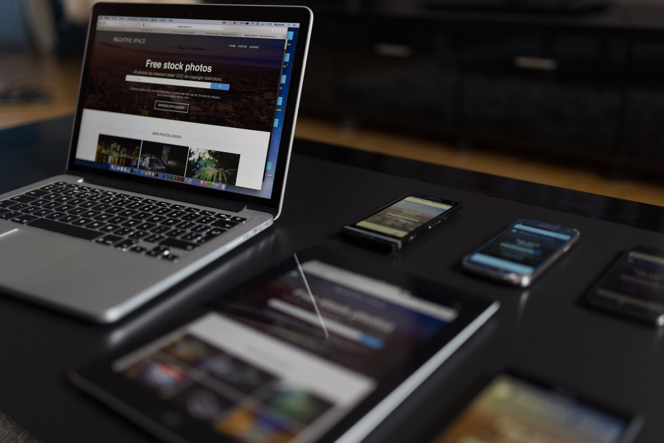 Laptop, tablet and phones on table